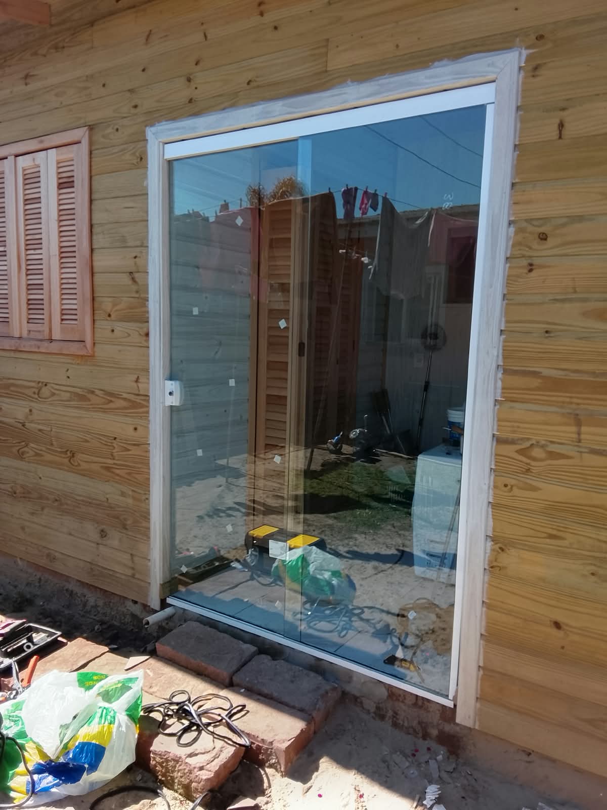 Porta de vidro deslizante com acabamento em madeira